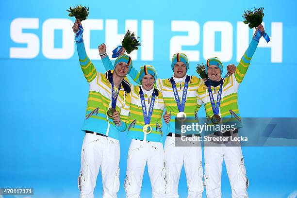 Gold medalists Andreas Wank, Marinus Kraus, Andreas Wellinger and Severin Freund of Germany celebrate during the medal ceremony for the Men's Team...