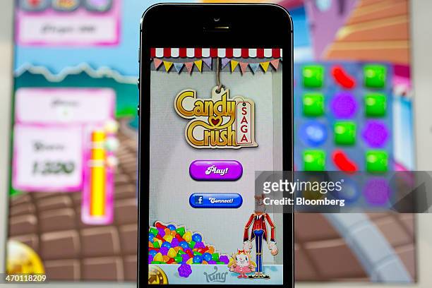The "Candy Crush Saga" game is displayed on an Apple Inc. IPhone 5s and iPad Air in this arranged photograph in Washington, D.C., U.S., on Tuesday,...
