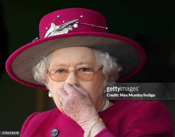 Queen Elizabeth II watches her horse 'Ring of Truth' run in the Al Basti Equiworld EBF Stallions Maiden Stakes during the Dubai Duty Free Spring...