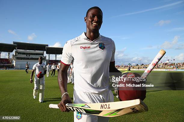 Jason Holder of West Indies raises his bat at the end of the drawn match after being undefeated on 103 runs during day five of the 1st Test match...