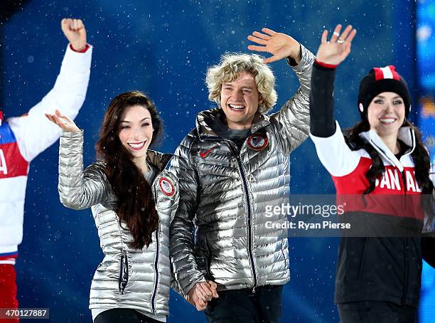 Gold medalists Meryl Davis and Charlie White of the United States and silver medalist Tessa Virtue of Canada celebrate during the medal ceremony for...