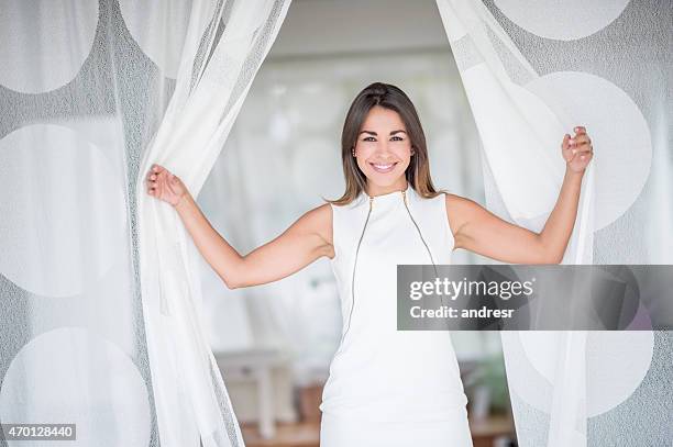 woman opening the curtains at home - beautiful curtains stock pictures, royalty-free photos & images