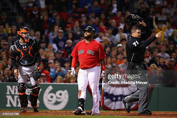 Pablo Sandoval of the Boston Red Sox reacts after being struck in the back by a pitch from Ubaldo Jimenez of the Baltimore Orioles during the fourth...