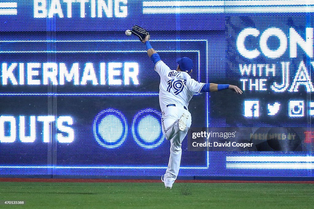 Andrelton Simmons (19) hits a double over the out stretched glove of Jose Bautista (19) of the Toronto Blue Jays