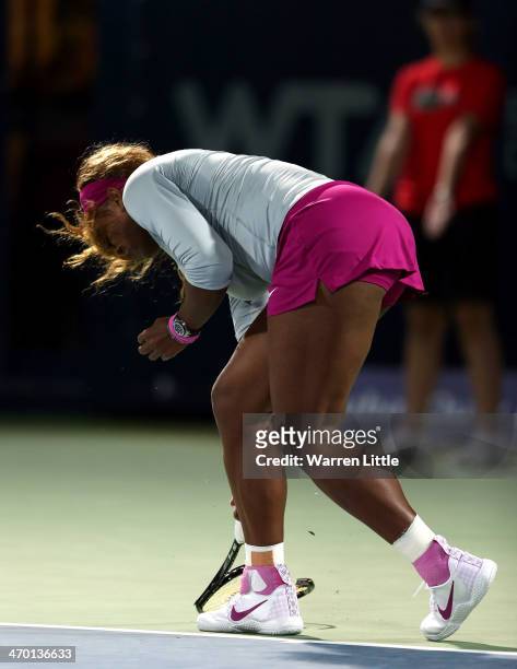 Serena Williams of the USA breaks her tennis racket in her match against Ekaterina Makarova of Russia during day two of the WTA Dubai Duty Free...