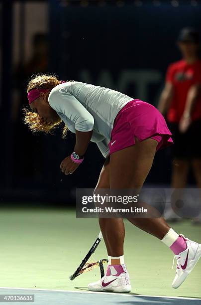 Serena Williams of the USA breaks her tennis racket in her match against Ekaterina Makarova of Russia during day two of the WTA Dubai Duty Free...