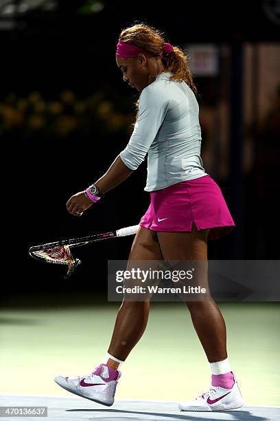 Serena Williams of the USA breaks her tennis racket in her match against Ekaterina Makarova of Russia during day two of the WTA Dubai Duty Free...