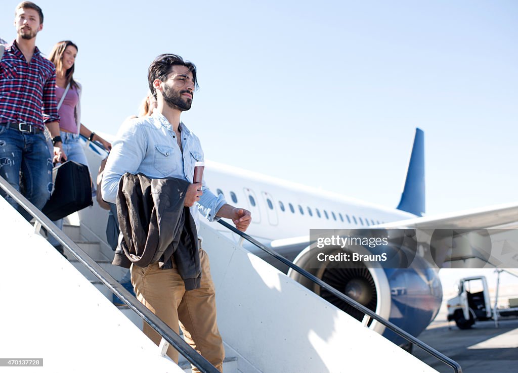 Young passengers getting out of the airplane.