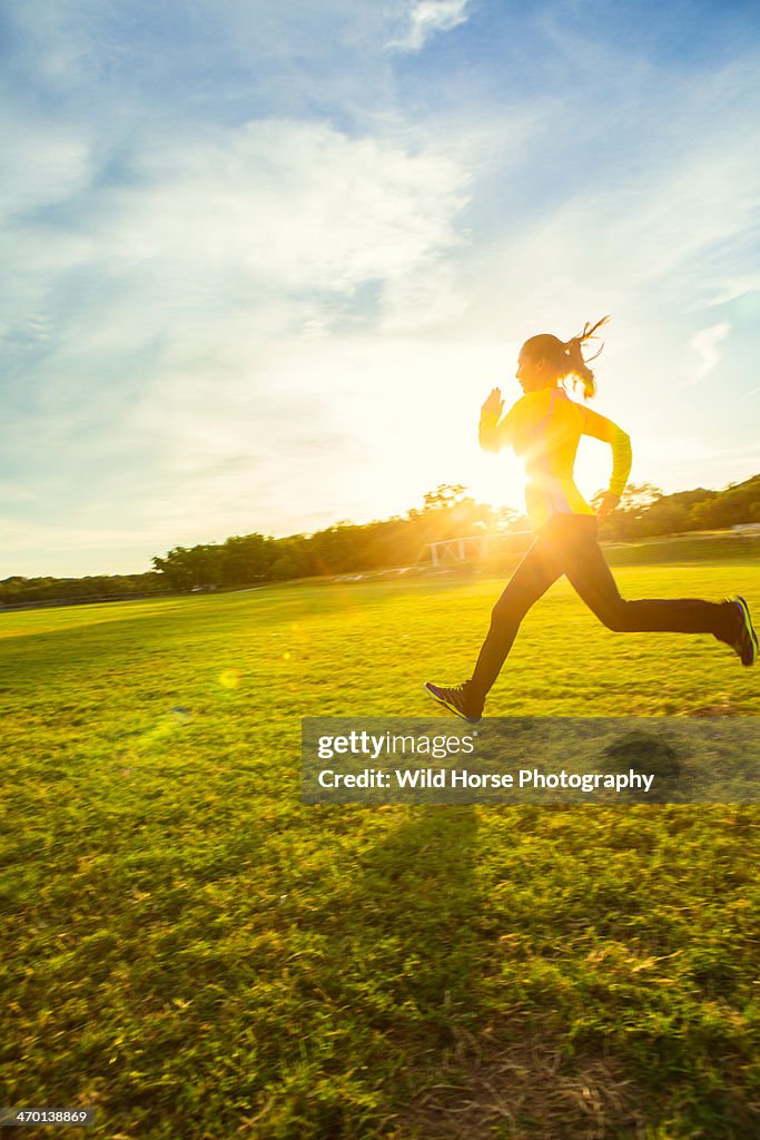 Girl running in sun flare