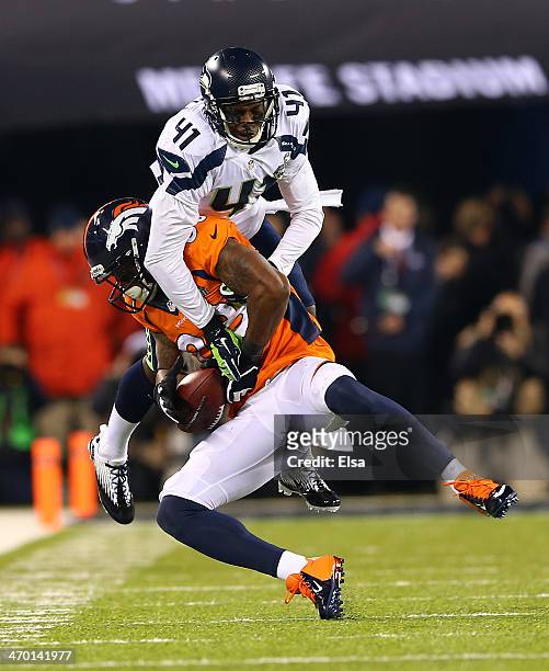 Wide receiver Demaryius Thomas of the Denver Broncos completes a pass for a 16 yard gain against the defense of cornerback Byron Maxwell of the...