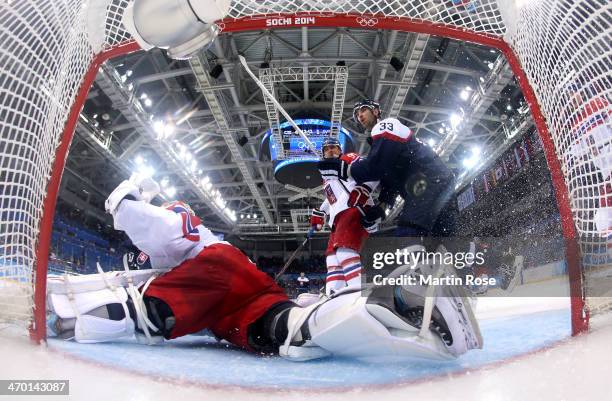 Marian Hossa of Slovakia shoots and scores against Ondrej Pavelec of Czech Republic in the third period during the Men's Qualification Playoff Game...
