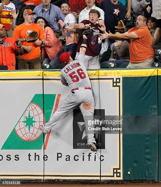 Kole Calhoun of the Los Angeles Angels of Anaheim leaps at the wall but cannot make a catch on a home run by Jason Castro of the Houston Astros in...