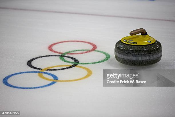 Winter Olympics: View of stone next to Olympic rings on ice during Women's Round Robin Session 10 at Ice Cube Curling Center. Equipment. Sochi,...