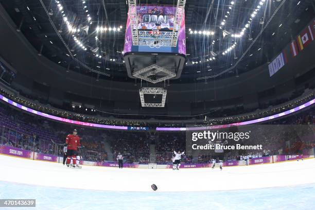 Lauris Darzins of Latvia celebrates an open net goal late in the third period against Switzerland during the Men's Ice Hockey Qualification Playoff...