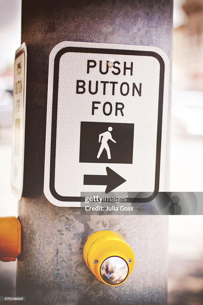 Sign for pedestrian stop light