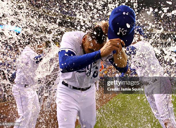 Paulo Orlando of the Kansas City Royals is doused with water by teammates Salvador Perez and Christian Colon after the Royals defeated the Oakland...