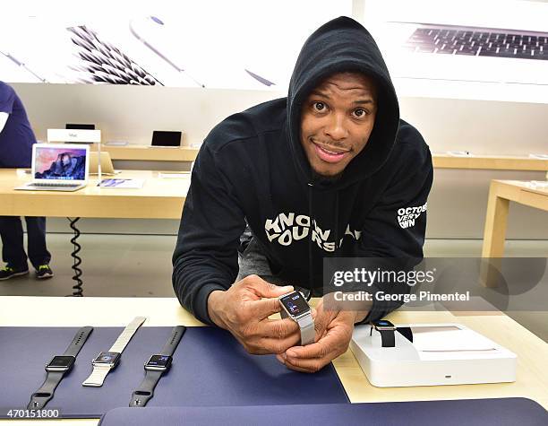 Toronto Raptor player Kyle Lowry tries on Apple Watch at the Apple Store Eaton Centre Toronto on April 17, 2015 in Toronto, Canada.