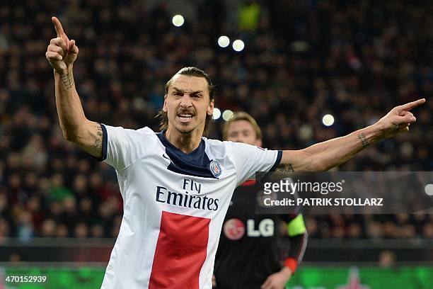 Paris Saint-Germain's Swedish forward Zlatan Ibrahimovic celebrates scoring during the first-leg round of 16 UEFA Champions League football match...