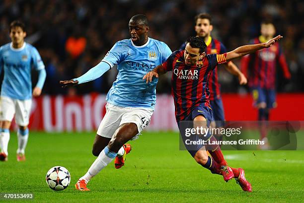 Xavi Hernandez of Barcelona battles with Yaya Toure of Manchester City during the UEFA Champions League Round of 16 first leg match between...