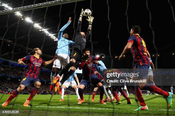 Victor Valdes of Barcelona rises to make a save under pressure during the UEFA Champions League Round of 16 first leg match between Manchester City...