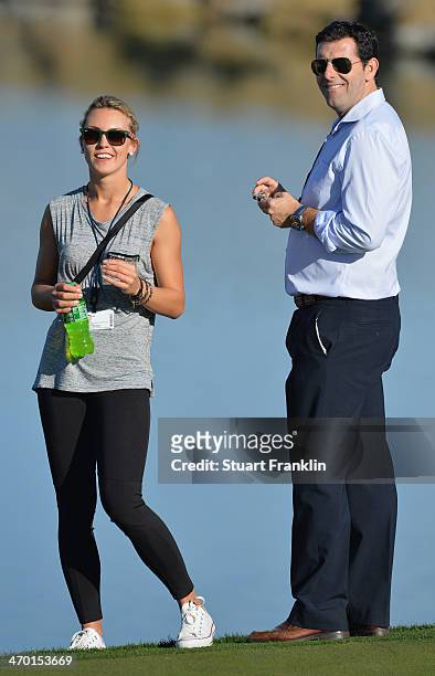 Katharina Boehm, girlfriend of Sergio Garcia of Spain and his manager look on during practice prior to the start of the World Golf Championships -...