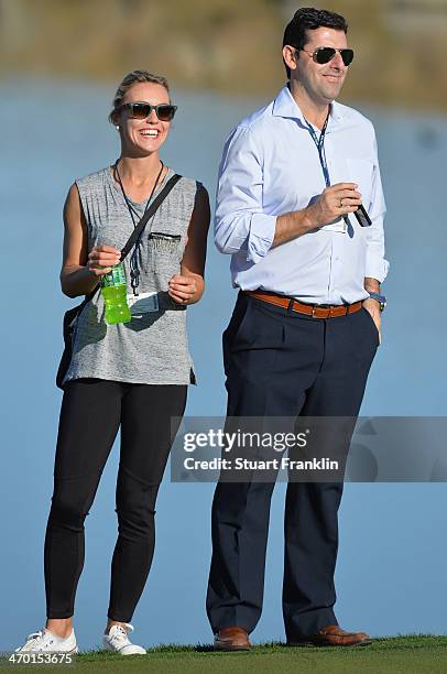 Katharina Boehm, girlfriend of Sergio Garcia of Spain and his manager look on during practice prior to the start of the World Golf Championships -...