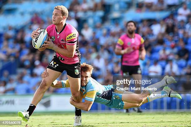 Matthew Moylan of the Panthers is tackled by Kane Elgey of the Titans during the round seven NRL match between the Gold Coast Titans and the Penrith...