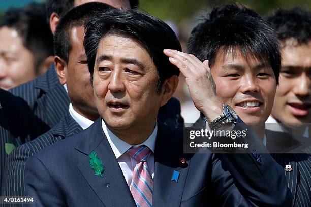 Shinzo Abe, Japan's prime minister, left, attends a cherry blossom viewing party at Shinjuku Gyoen National Garden in Tokyo, Japan, on Saturday,...