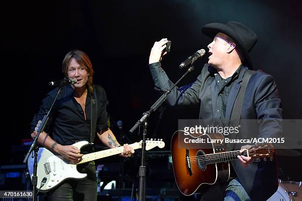 Host Garth Brooks poses for a selfie photo while performing onstage with recording artist Keith Urban during the ACM Lifting Lives Gala at the Omni...