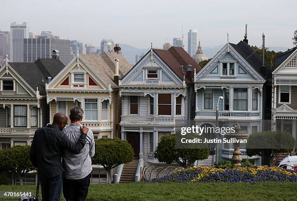 People stop to look at San Francisco's famed Painted Ladies victorian houses on February 18, 2014 in San Francisco, California. According to a report...