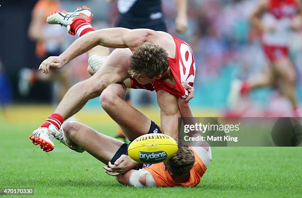 Luke Parker of the Swans is caught by Lachie Whitfield of the Giants during the round three AFL match between the Sydney Swans and the Greater...