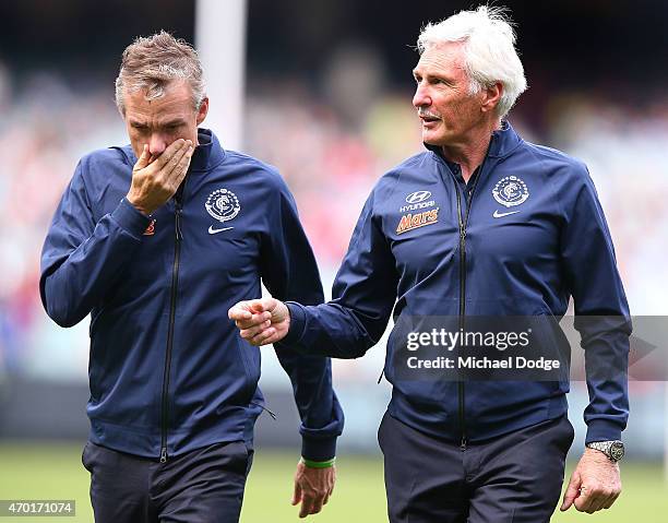 Blues head coach Michael Malthouse and his assistant Dean Laidley walk off after warm up during the round three AFL match between the Carlton Blues...