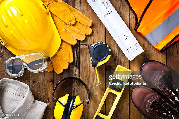 personal safety workwear and construction blueprint shot directly above - protective workwear stock pictures, royalty-free photos & images