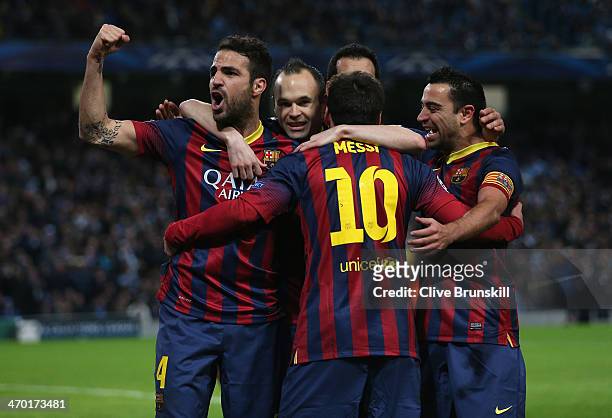 Lionel Messi of Barcelona celebrates scoring the opening goal from a penalty kick with his team-mates during the UEFA Champions League Round of 16...