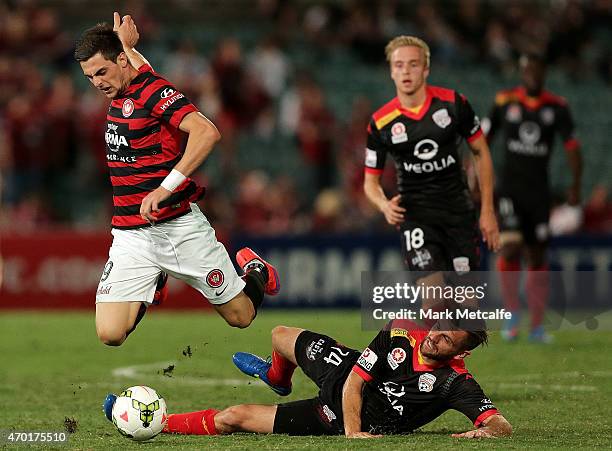 Tomi Juric of the Wanderers is tackled by Cameron Watson of United during the round 26 A-League match between the Western Sydney Wanderers and...