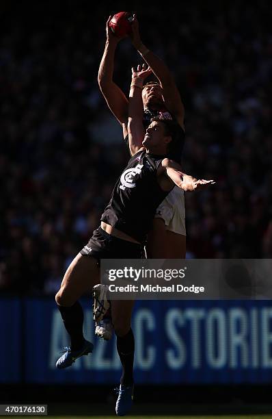 Tom Bellchambers of the Bombers marks the ball over Cameron Wood of the Blues during the round three AFL match between the Carlton Blues and the...