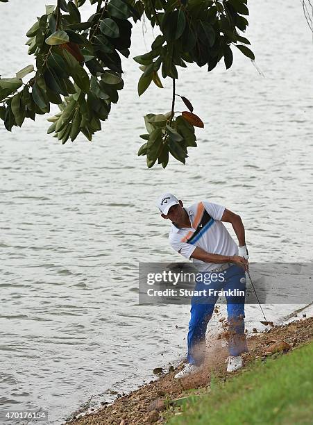 Pablo Larrazabal of Spain plays a shot from near the water on the 17th hole during the third round of the Shenzhen International at Genzon Golf Club...