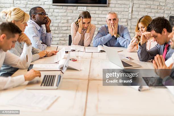 large group of worried business people having a meeting. - office frustration stock pictures, royalty-free photos & images