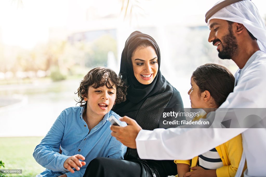 Emirati family using a smart phone