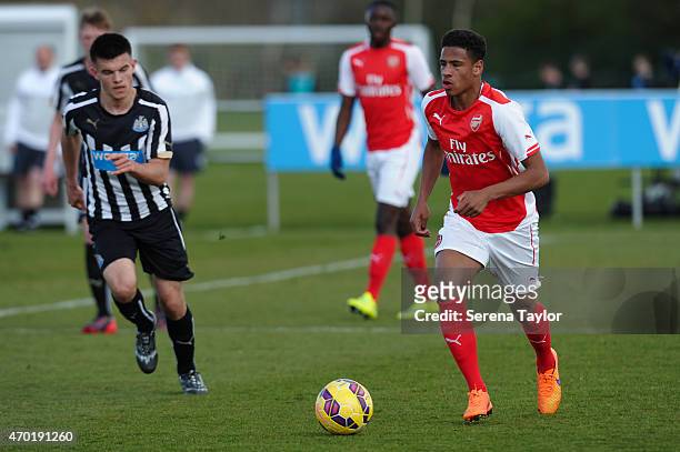 Marcus Asyei-Tabi of Arsenal runs with the ball whilst being pursued by Dan Ward of Newcastle during the U18 Premier League Match between Newcastle...