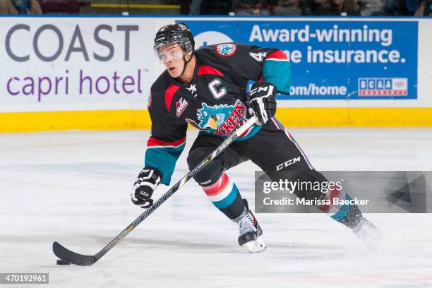 Madison Bowey of the Kelowna Rockets stops with the puck against the Red Deer Rebels on November 6, 2013 at Prospera Place in Kelowna, British...