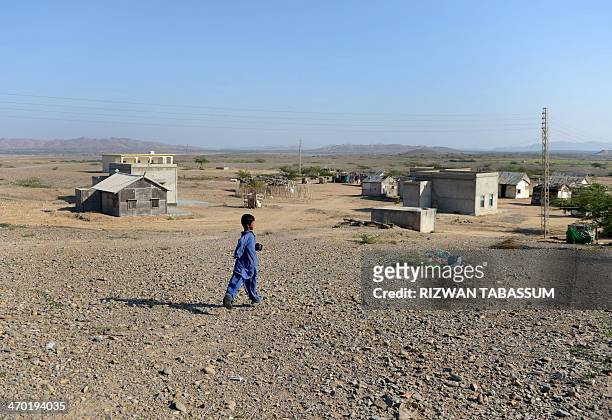 To go with story 'Pakistan-energy-coal' by Ashraf Khan In this photograph taken on December 11, 2013 a Pakistan village boy walks at the proposed...