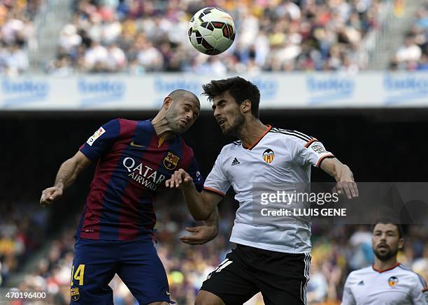 Barcelona's Argentinian midfielder Javier Mascherano vies with Valencia's Portuguese midfielder Andre Gomes during the Spanish league football match...