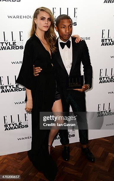 Cara Delevinge and Pharrell Williams poses in the winners room at the Elle Style Awards 2014 at one Embankment on February 18, 2014 in London,...