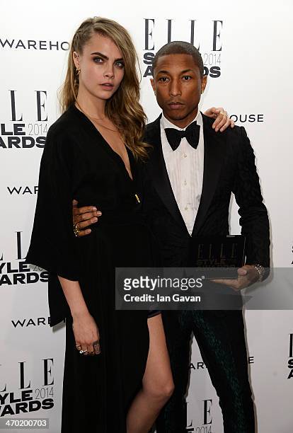 Cara Delevinge and Pharrell Williams poses in the winners room at the Elle Style Awards 2014 at one Embankment on February 18, 2014 in London,...
