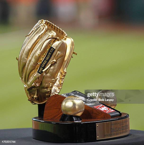 Dallas Keuchel of the Houston Astros receives his Rawlings gold glove from Mike Falby of Rawlings at Minute Maid Park on April 17, 2015 in Houston,...