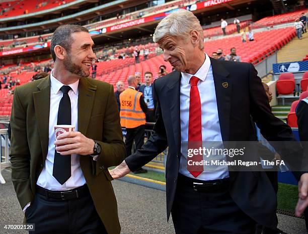 Arsene Wenger, manager of Arsenal, chats to former Arsenal player Martin Keown prior to the FA Cup Semi-Final match between Arsenal and Reading at...