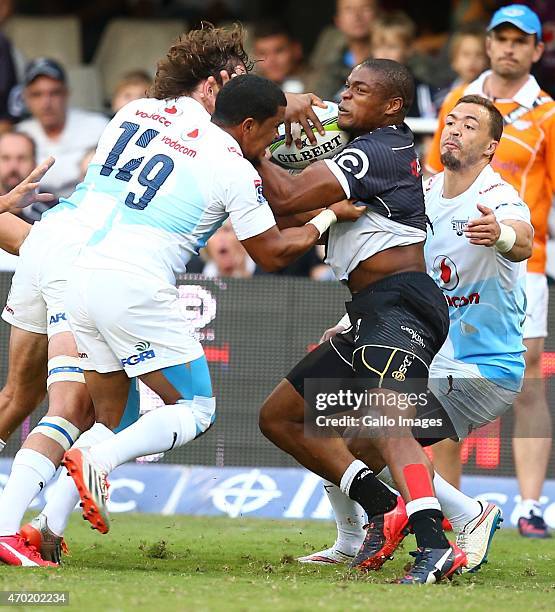 Sibusiso Sithole of the Sharks is tackled by 3 of the Vodacom Blue Bulls players during the Super Rugby match between Cell C Sharks and Vodacom Bulls...