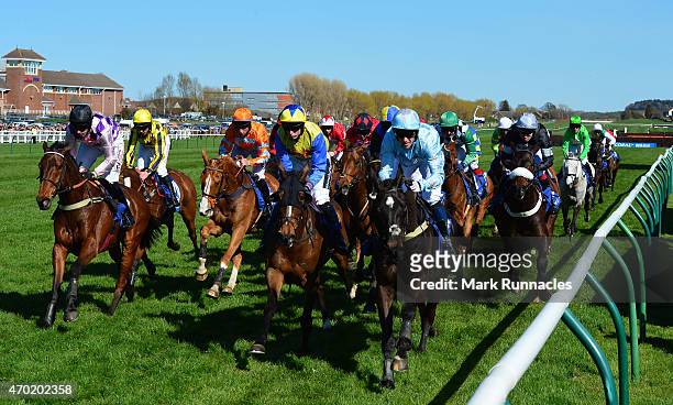 Riders bunched together on the second lap of the Coral Scottish Grand National Handicap Chase on the second day of the Scottish Grand National...