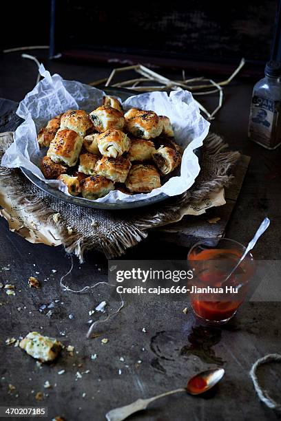 mini pork, apple & pistachio sausage rolls - sausage roll stock pictures, royalty-free photos & images